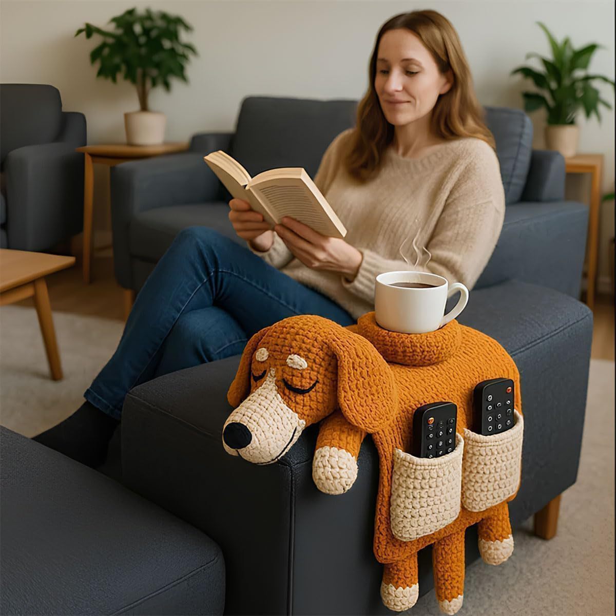 Woman reading beside a dog-shaped sofa armrest organizer