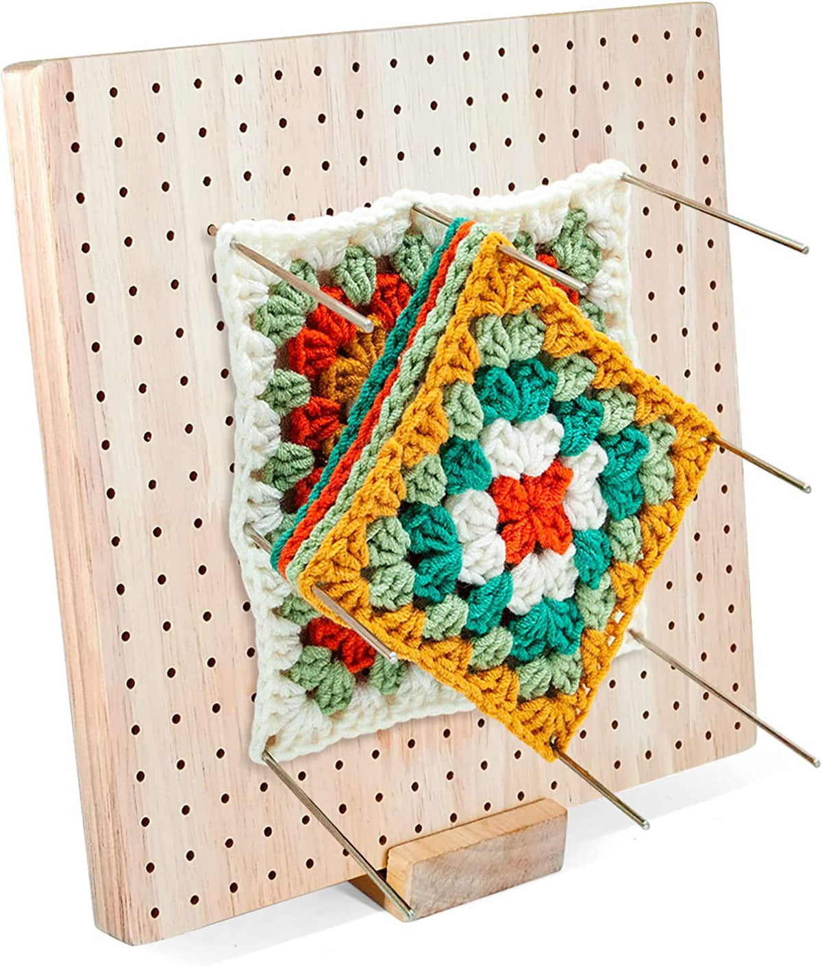 Granny squares pinned on a blocking board
