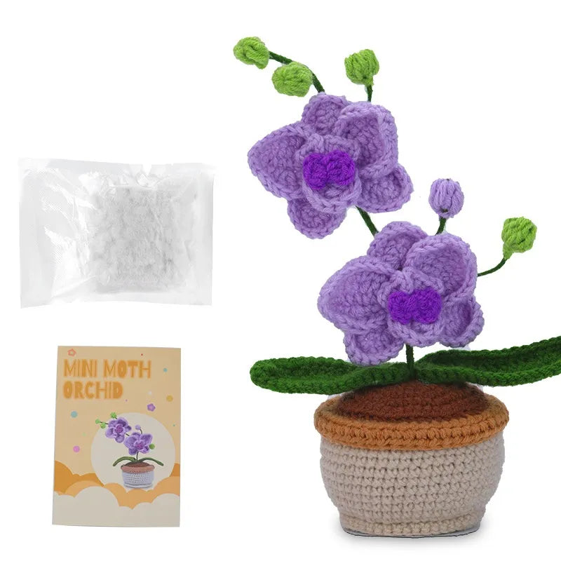 Purple mini orchid crochet project with green leaves, crocheted pot and English instruction booklet