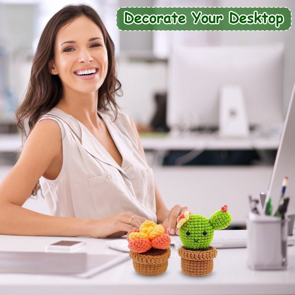 Person at a desk beside crochet flower and cactus pots