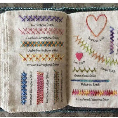 Open embroidery book with herringbone, heart and chain stitch samples