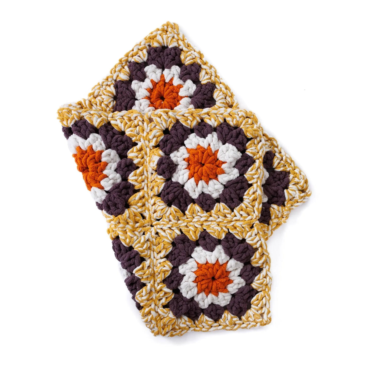 Folded granny square blanket showing overlapping colorful motifs