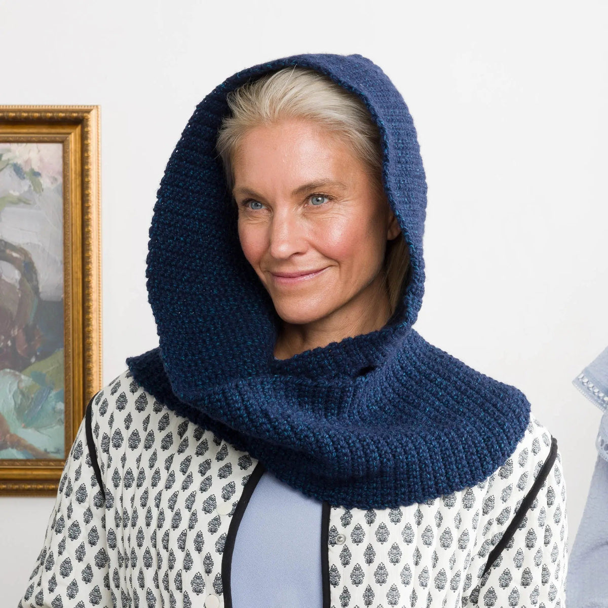 Model wearing a navy crochet hooded scarf