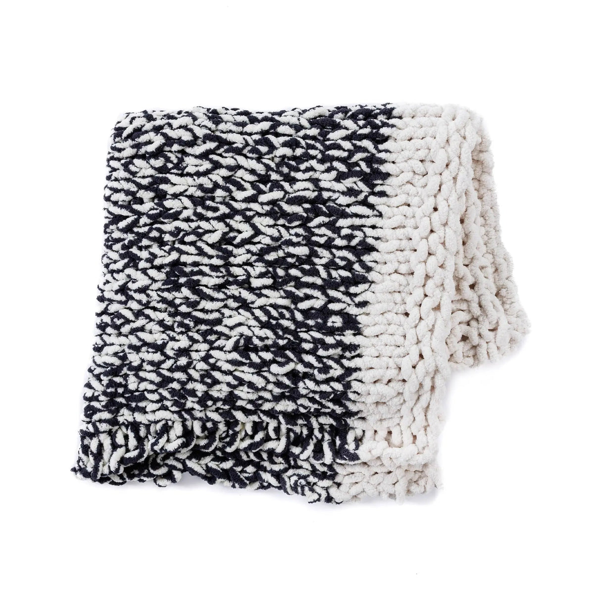 Folded black and cream knit blanket showing its chunky texture