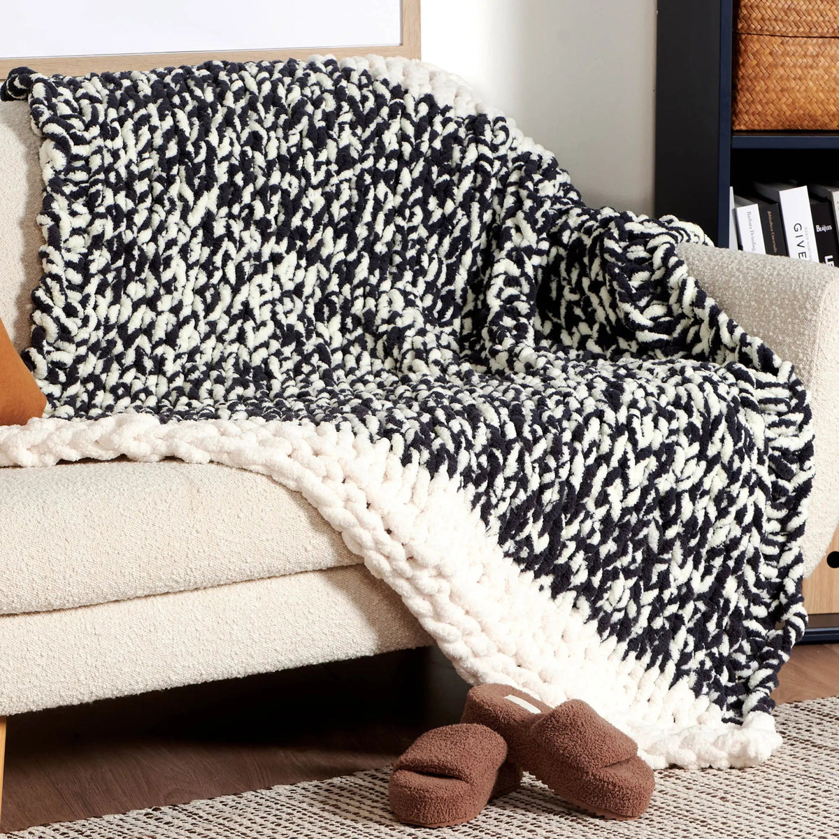 Black and cream knit blanket draped over a seat