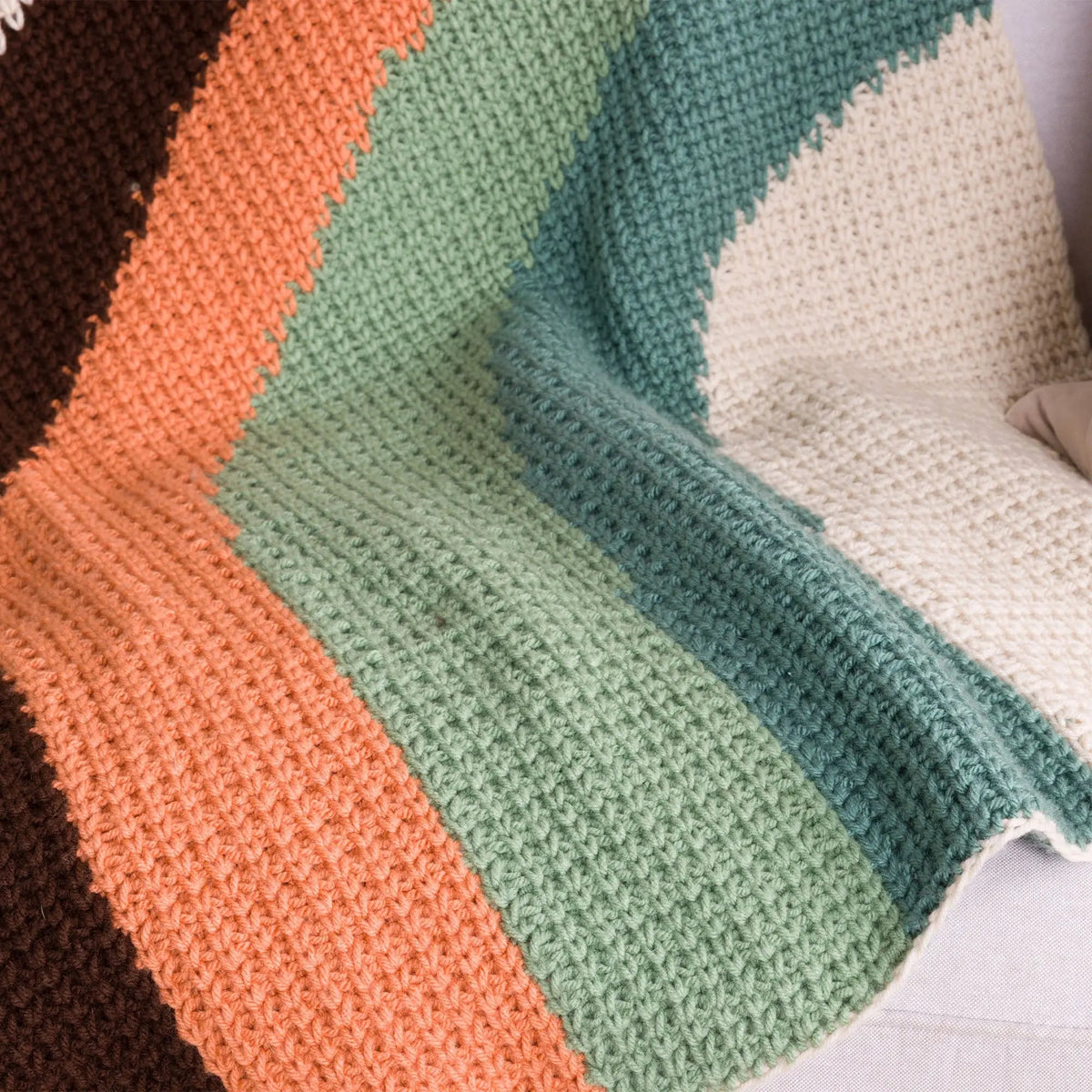 Close-up of the Calm Current blanket stitches and curved color bands