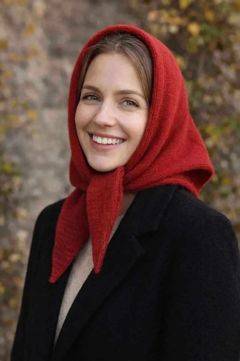 Red knitted triangle scarf worn over the head