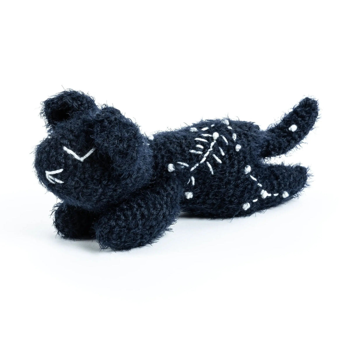 Angled view of the sleepy crochet cat and constellation stitching