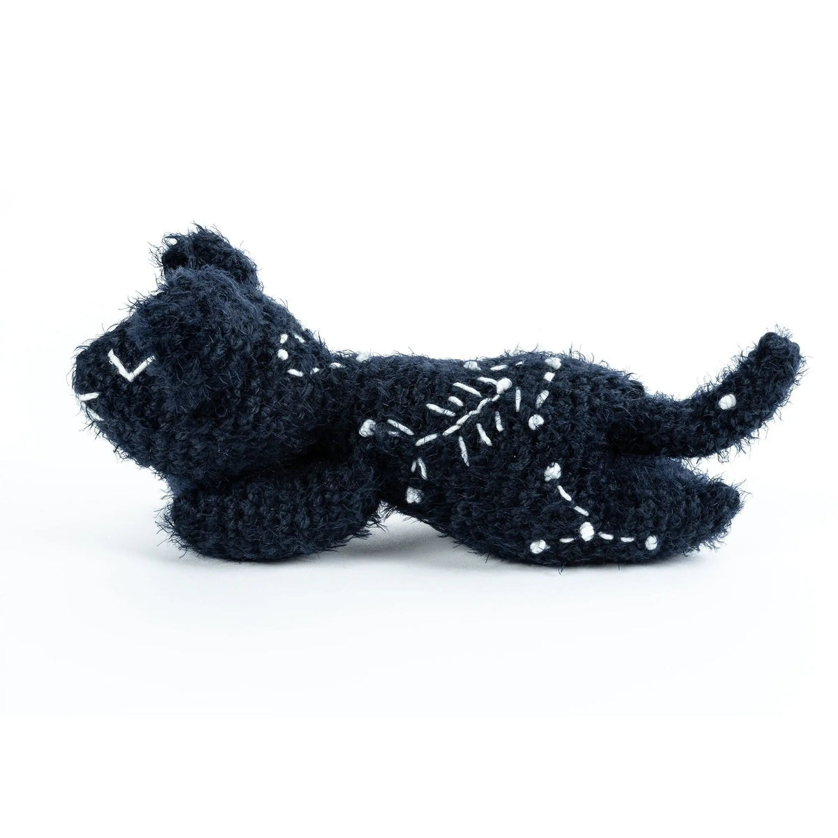 Opposite side of the crochet cat showing its curled tail and stitched stars