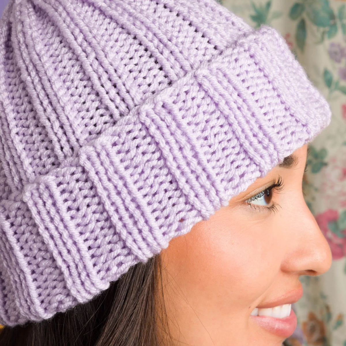 Side view of the lavender hat showing its ribbed brim