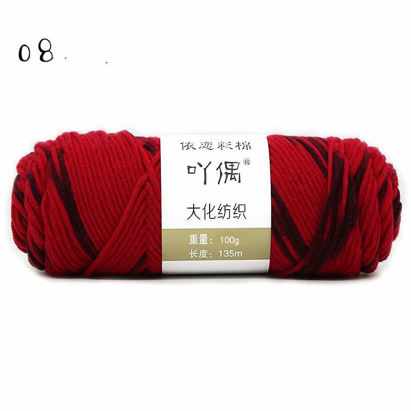 Red and black yarn skein with a paper label
