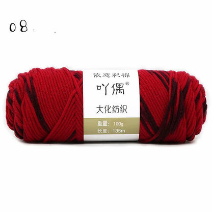 Red and black yarn skein with a paper label