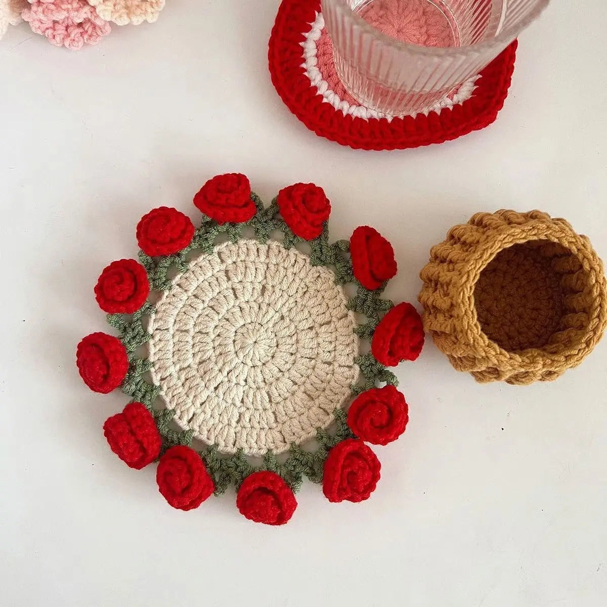 Rose-edged crochet coaster beside a small basket